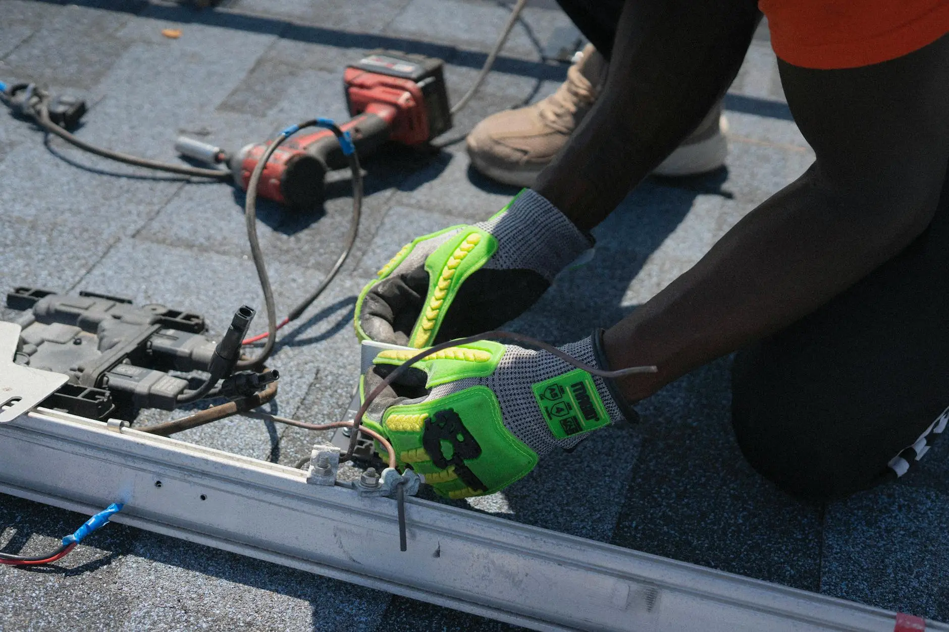 A professional roofing crew installing high-quality shingles on a home in Sandy, Utah, under a clear blue sky.