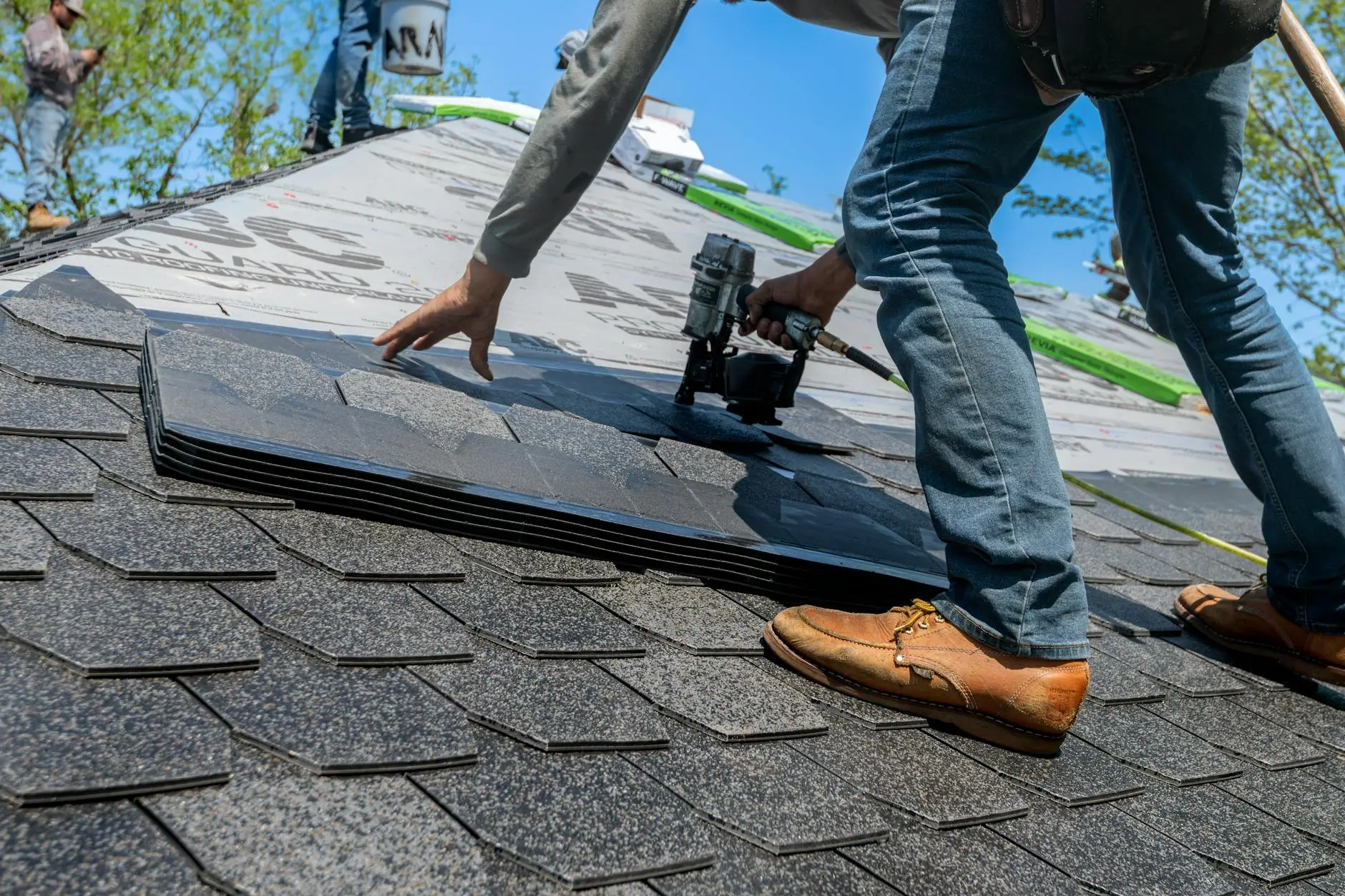 A professional roofing inspector examining shingles on a Murray home, checking for hail damage and granule loss.